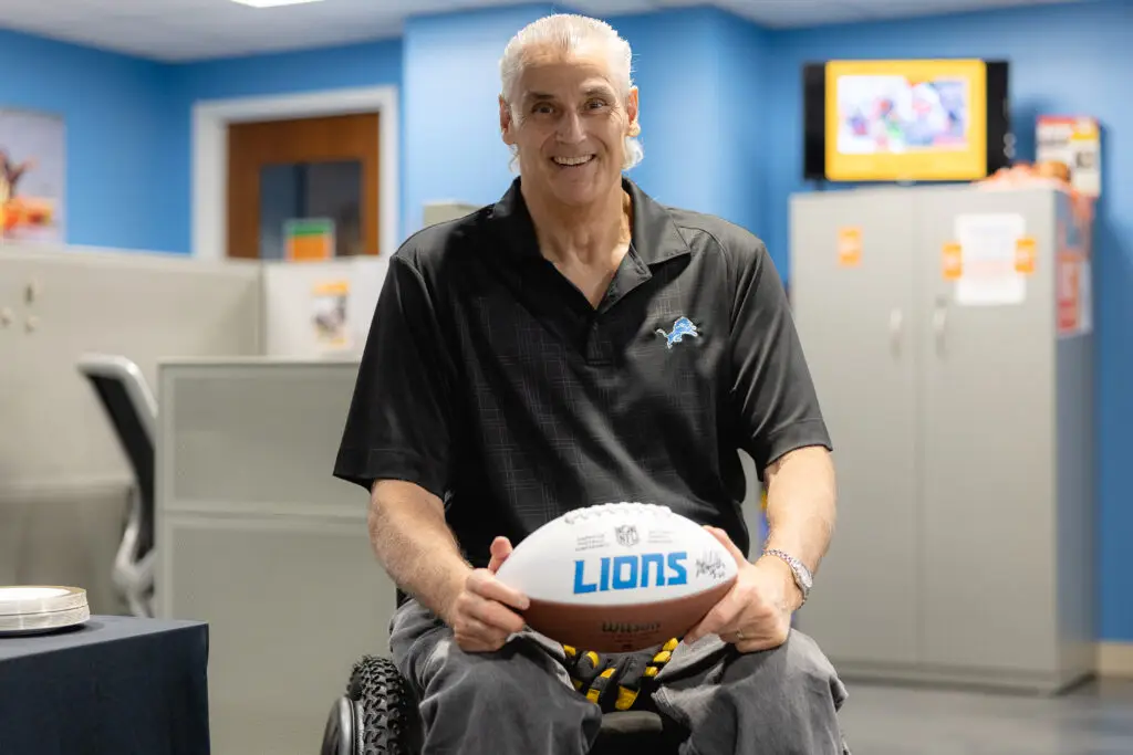 Mike Utley holding a Detroit Lions football