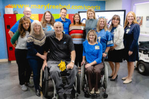 Mike Utley is shown with his care team in the wheelchair and adaptive sports office at Mary Free Bed